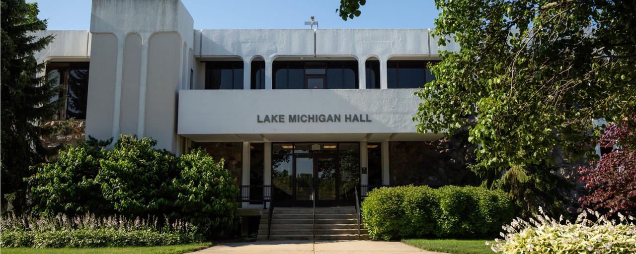Lake Michigan Hall and surrounding trees, bushes, flowers
